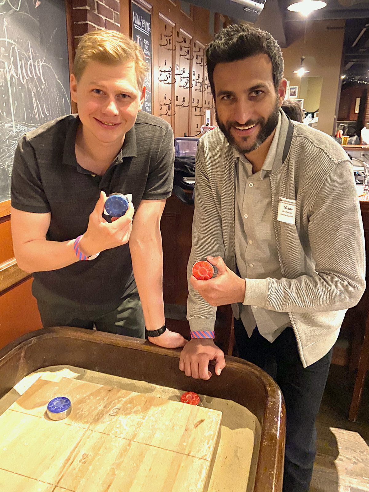 two HEAA members playing air foos ball